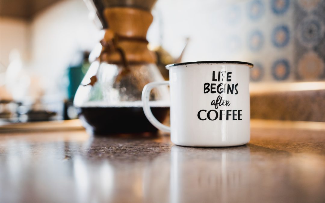 An image of a close up cup of coffee, with the writing "Life Begins After Coffee"